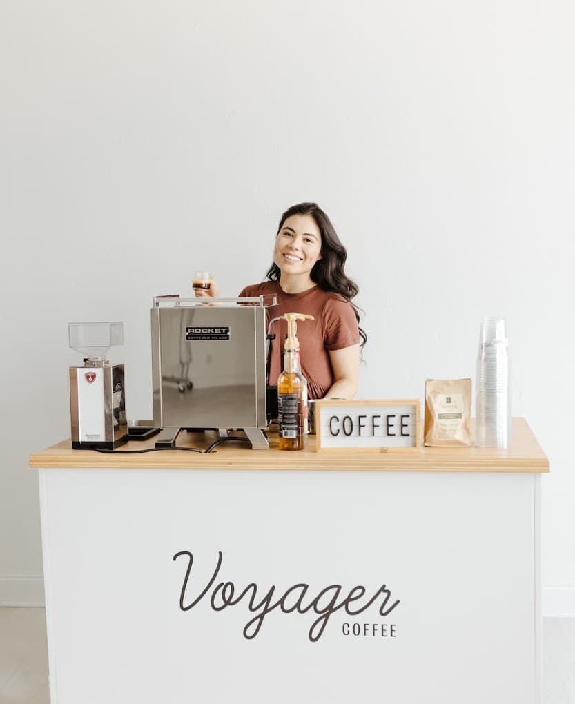 Professional barista serving espresso at Voyager Coffee cart - Coffee catering in Omaha NE for hire